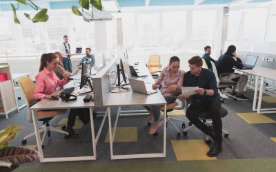 The collaborative process of the multicultural skilled young business team during brainstorming meeting in office. Diverse group of young people dressed in formal wear cooperating on developing design