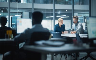 Diverse Team of Managers Working and Having Discussions in Modern Big City Office. Colleagues Work on New Business Opportunities, CEO Having Meeting with Employee, Talking About Investing in Future.
